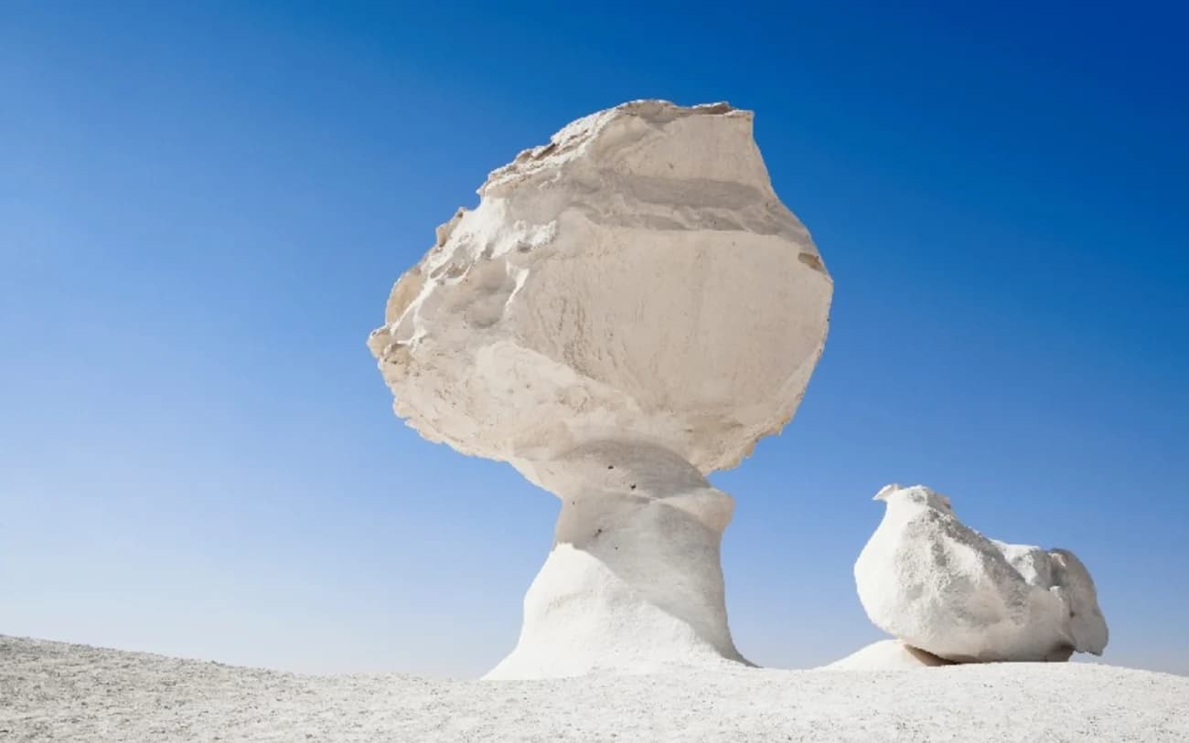 Journey into one of Egypt's most surreal landscapes, where chalk rock formations and vast golden sands create an otherworldly desert experience.
